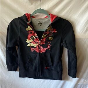 Nike Black Zip-Up with Red and Gold Dragon Design this is a child's hoodie